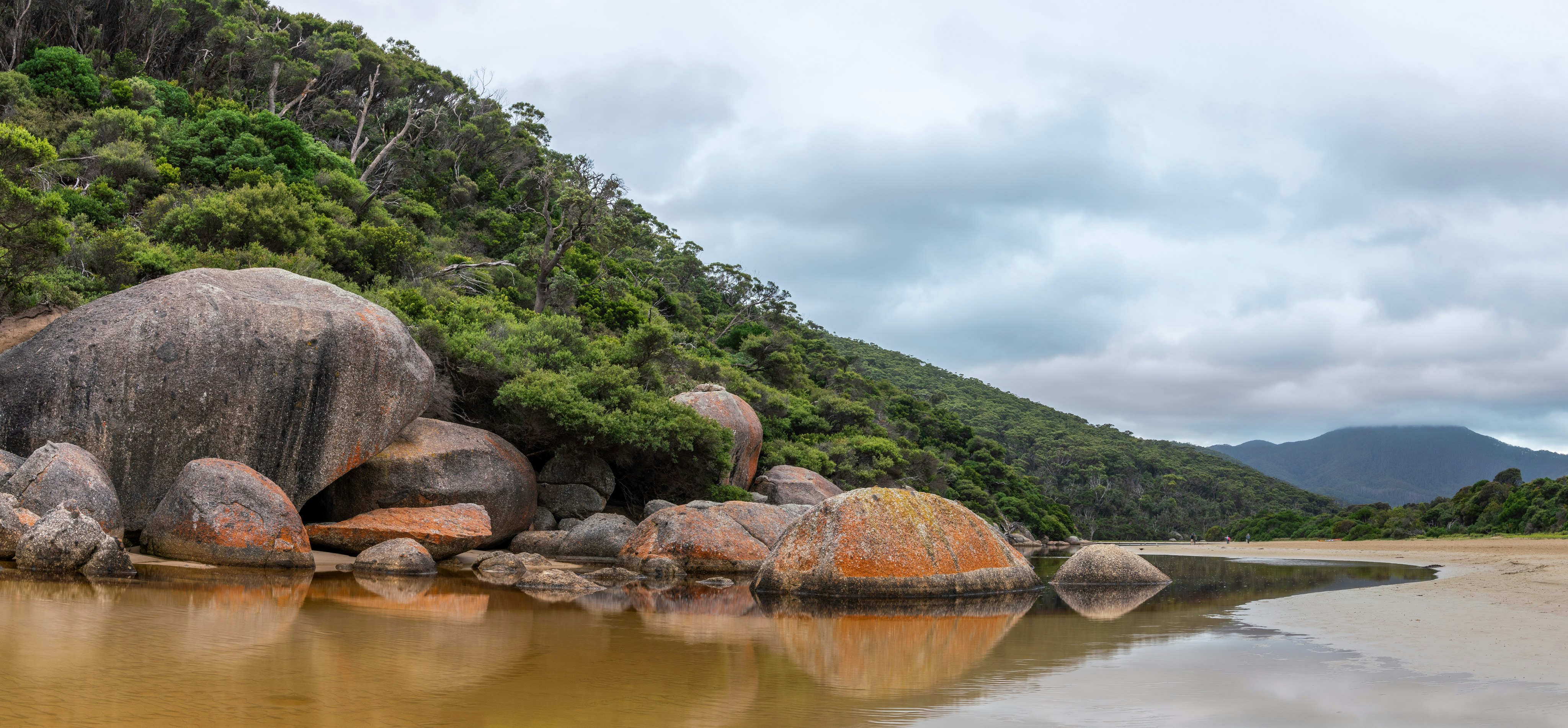 boulders facing body of water